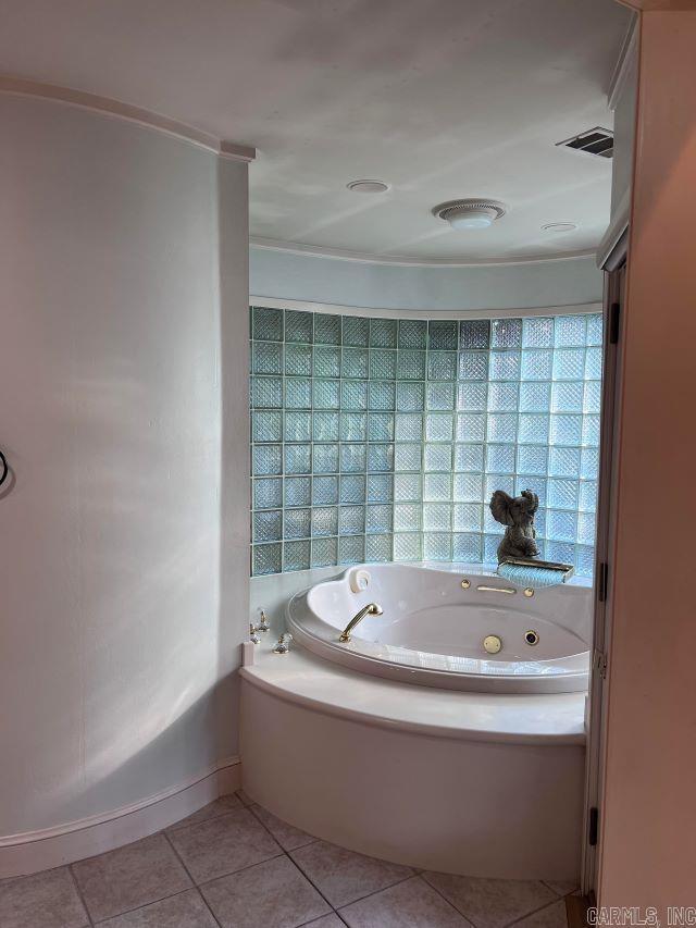 bathroom featuring tile patterned flooring and a bathtub