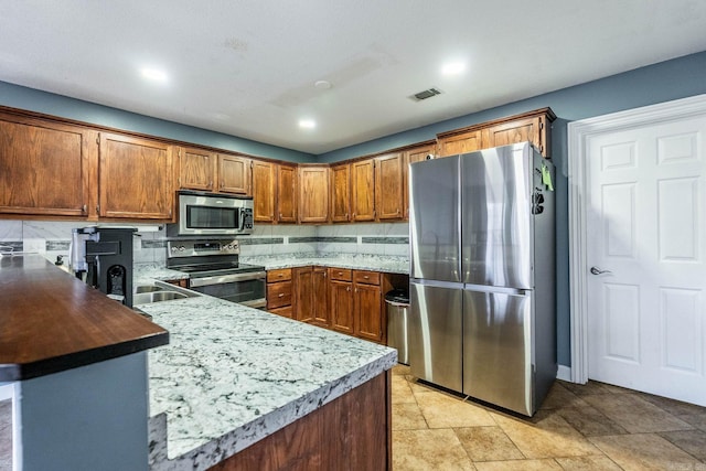 kitchen with decorative backsplash, stainless steel appliances, and sink