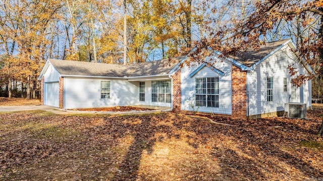 view of front of house featuring central AC unit and a garage