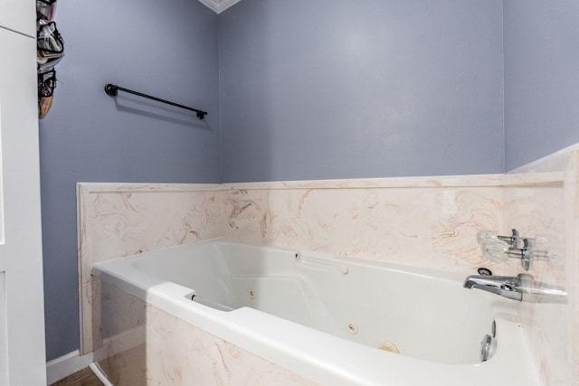 bathroom with a relaxing tiled tub