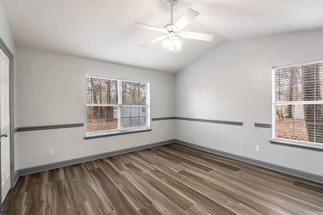 unfurnished room featuring dark hardwood / wood-style floors, ceiling fan, a textured ceiling, and vaulted ceiling