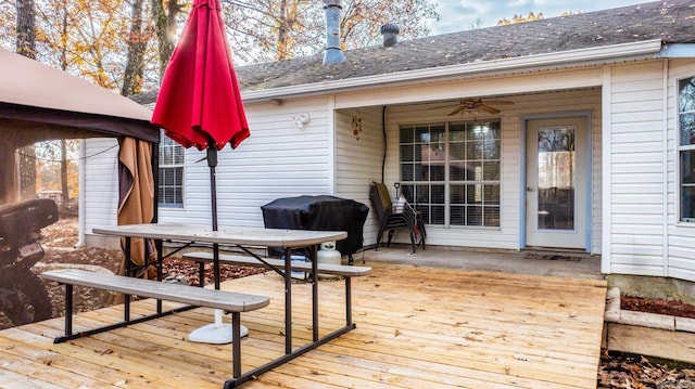 wooden terrace with a gazebo, grilling area, and ceiling fan