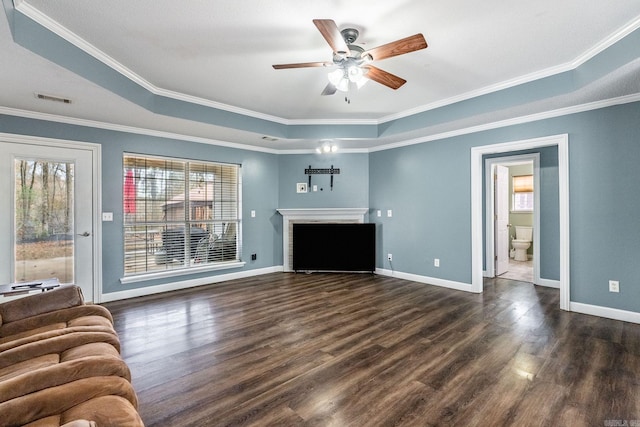 unfurnished living room featuring a tray ceiling, dark hardwood / wood-style flooring, and ornamental molding