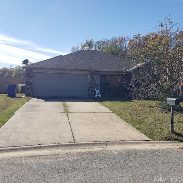 single story home with a front yard and a garage