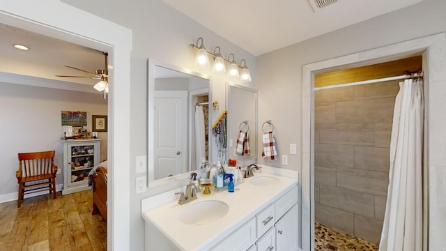 full bathroom with visible vents, a sink, and tiled shower