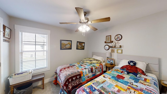 bedroom with a ceiling fan, carpet flooring, and baseboards