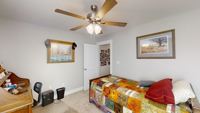 bedroom featuring baseboards, a ceiling fan, and light colored carpet