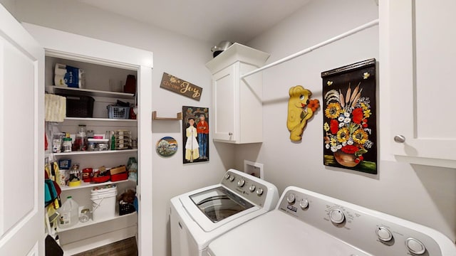 washroom featuring cabinets, independent washer and dryer, and dark hardwood / wood-style flooring