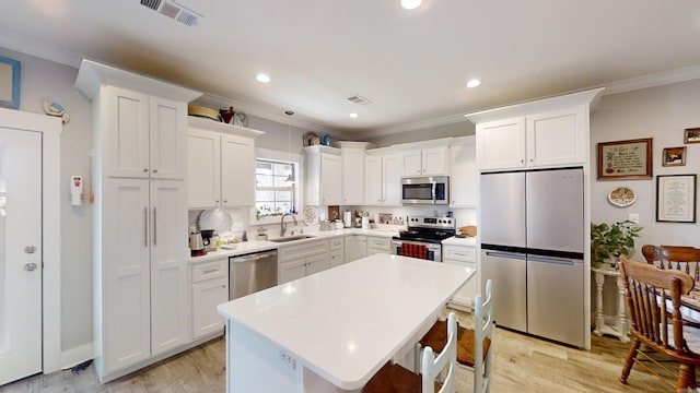 kitchen with white cabinetry, light hardwood / wood-style floors, and appliances with stainless steel finishes