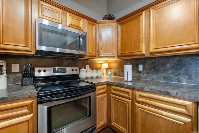 kitchen with stainless steel appliances and tasteful backsplash