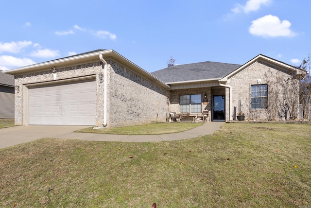 view of front of home with a front yard and a garage