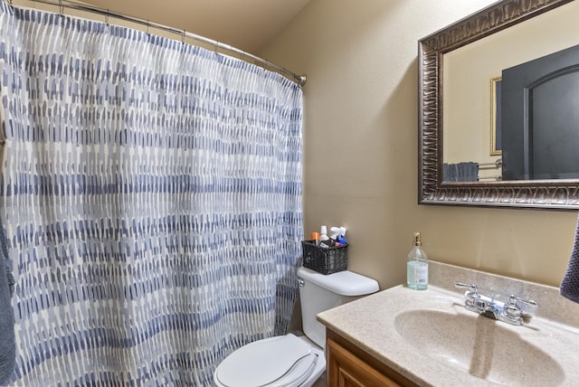 bathroom featuring a shower with curtain, vanity, and toilet