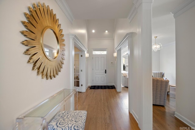 interior space with hardwood / wood-style flooring, crown molding, and a notable chandelier