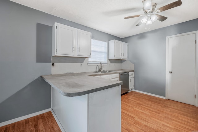 kitchen with kitchen peninsula, white cabinetry, dishwasher, and light hardwood / wood-style flooring