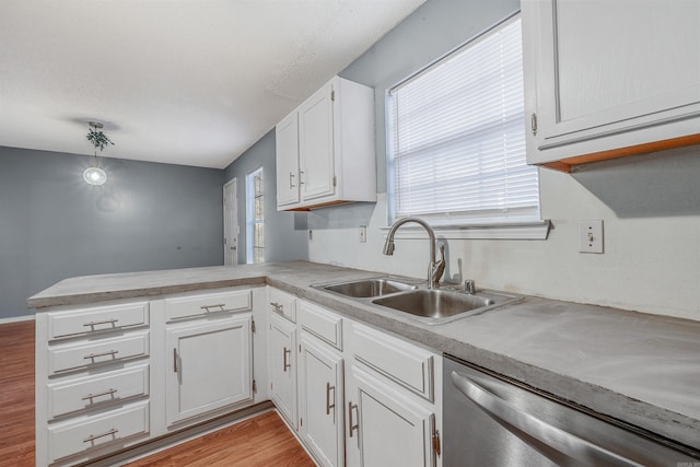 kitchen featuring kitchen peninsula, sink, light hardwood / wood-style flooring, stainless steel dishwasher, and white cabinetry