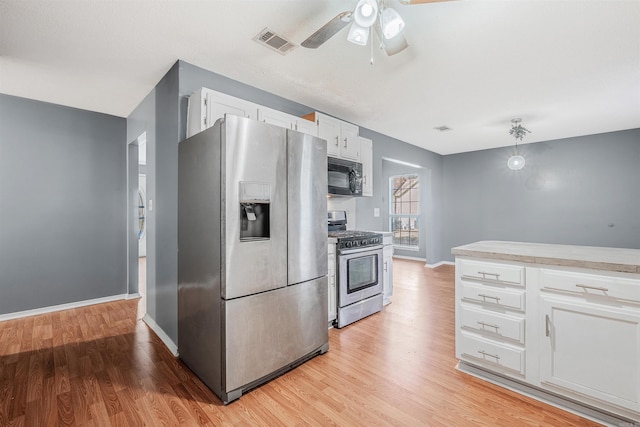 kitchen with white cabinets, light wood-type flooring, stainless steel appliances, and ceiling fan