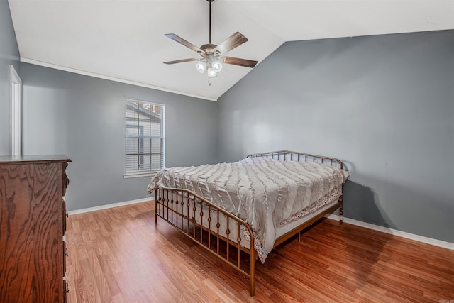 bedroom featuring hardwood / wood-style floors, vaulted ceiling, and ceiling fan