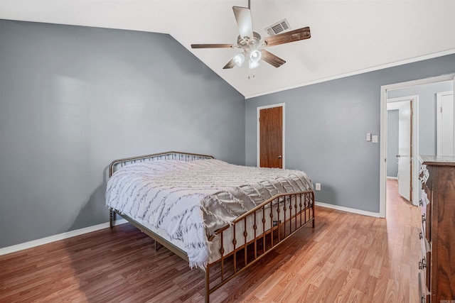 bedroom featuring ceiling fan, light wood-type flooring, and vaulted ceiling