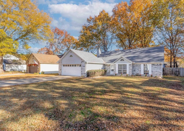 view of front of home with a front yard and a garage