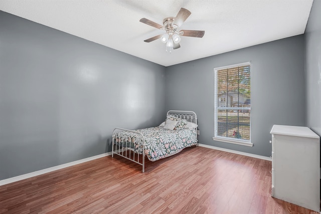 bedroom featuring wood-type flooring and ceiling fan