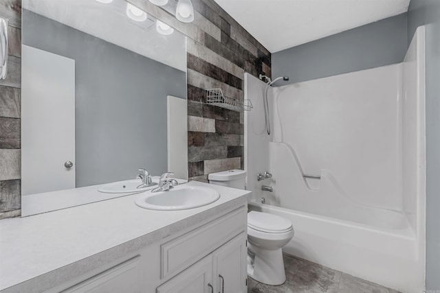 full bathroom featuring tile patterned flooring, tiled shower / bath combo, toilet, and vanity