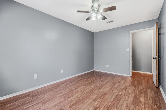 unfurnished room with hardwood / wood-style floors and ceiling fan