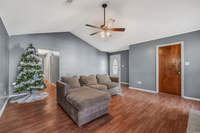 living room featuring hardwood / wood-style flooring, vaulted ceiling, and ceiling fan