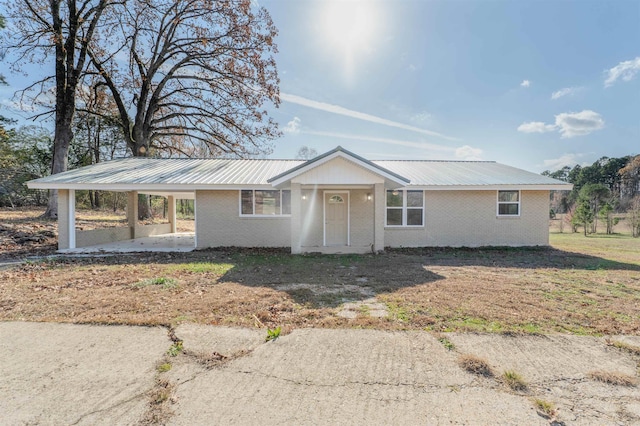 ranch-style home featuring a carport