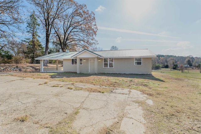 ranch-style home featuring a front yard and a carport