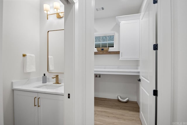 bathroom with hardwood / wood-style floors and vanity