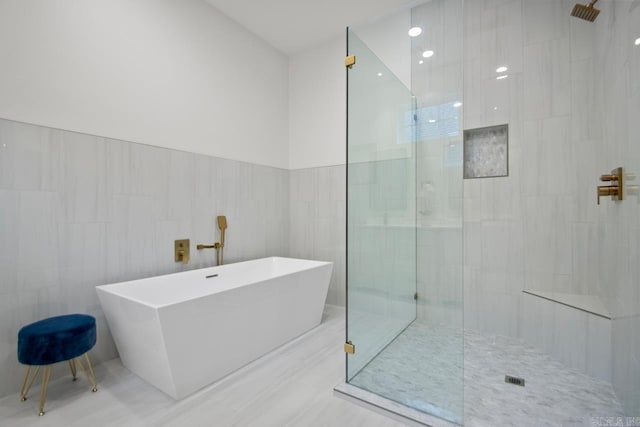 bathroom with plus walk in shower and tile walls