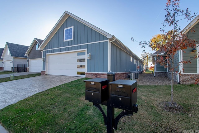 view of front of house featuring a garage, a front yard, and central AC