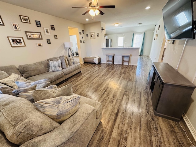 living room featuring ceiling fan and wood-type flooring