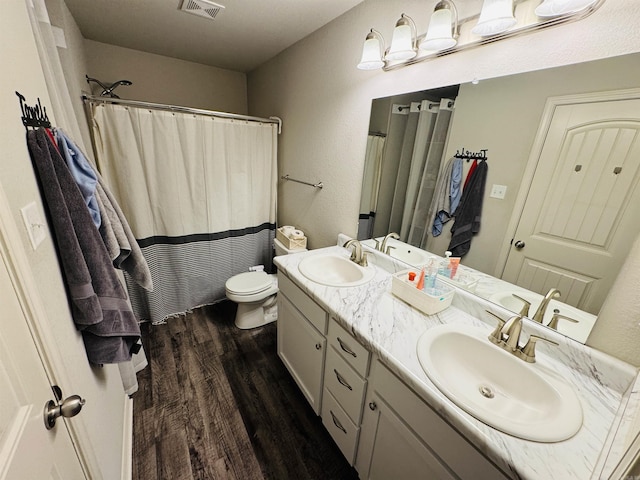 bathroom with a shower with curtain, toilet, vanity, and hardwood / wood-style flooring