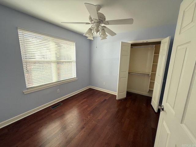 unfurnished bedroom featuring ceiling fan, a closet, and dark hardwood / wood-style floors