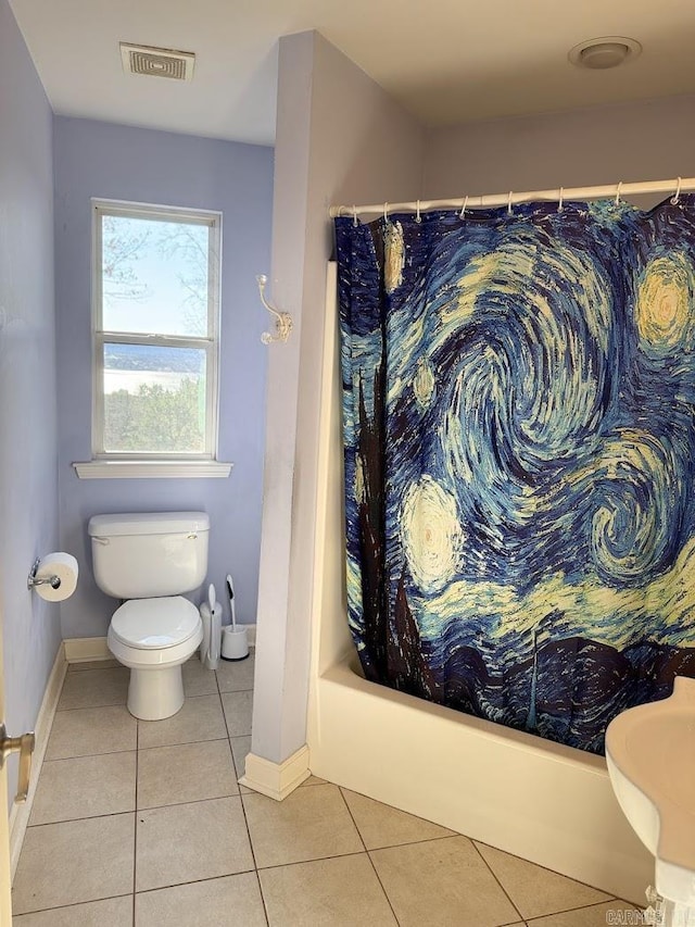 bathroom with tile patterned floors, toilet, and shower / bath combo with shower curtain