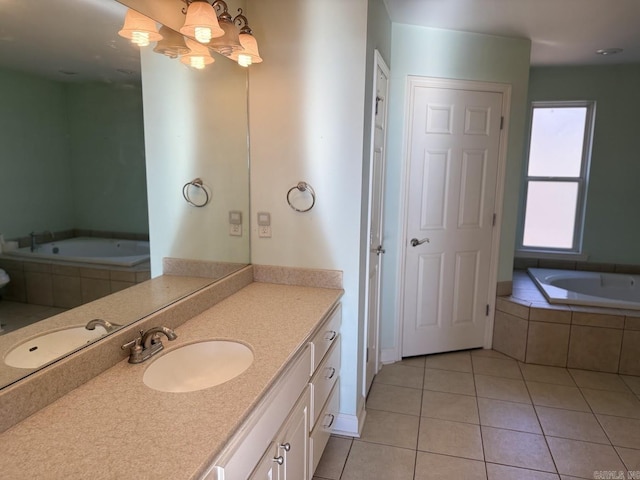 bathroom featuring tile patterned floors, tiled tub, and vanity