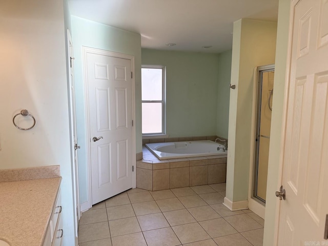 bathroom with plus walk in shower, tile patterned flooring, and vanity