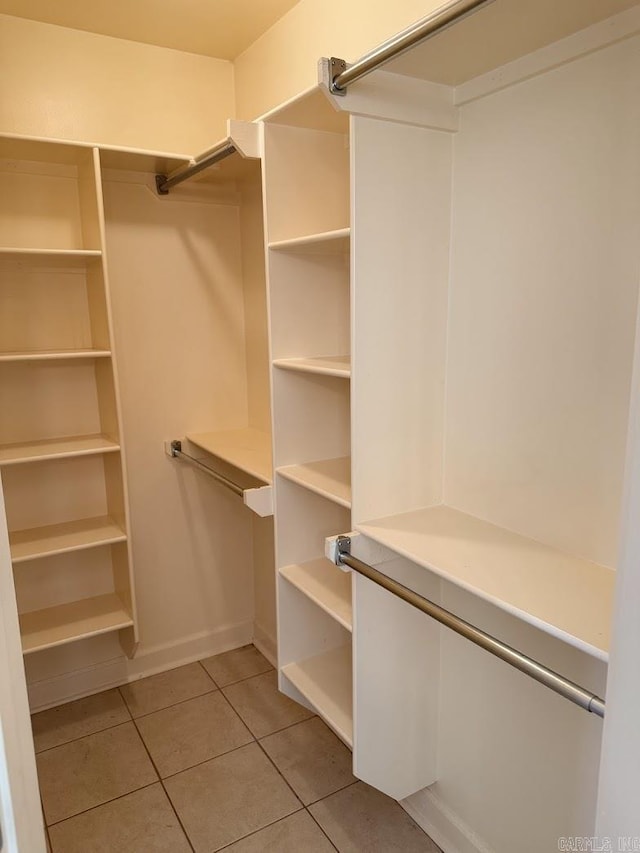 spacious closet with light tile patterned flooring