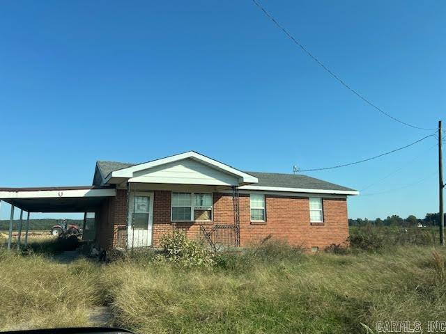 view of side of property with a carport