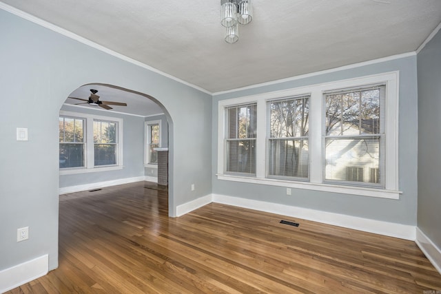 unfurnished dining area with a textured ceiling, ceiling fan, wood-type flooring, and crown molding