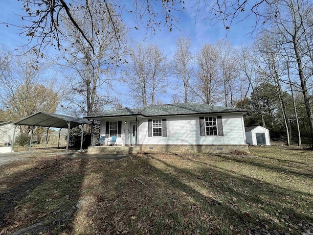 view of front of property featuring a front lawn, a storage unit, a porch, and a carport