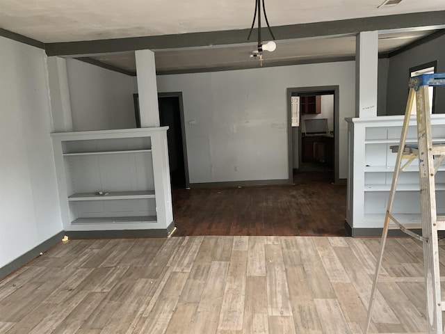 interior space featuring beamed ceiling and hardwood / wood-style flooring