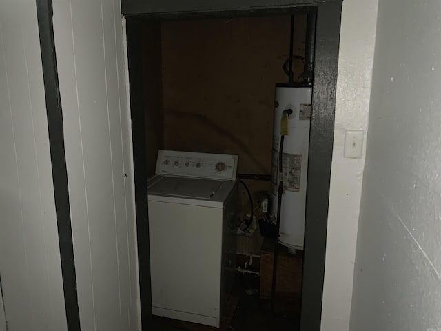 laundry area with water heater and washer / dryer