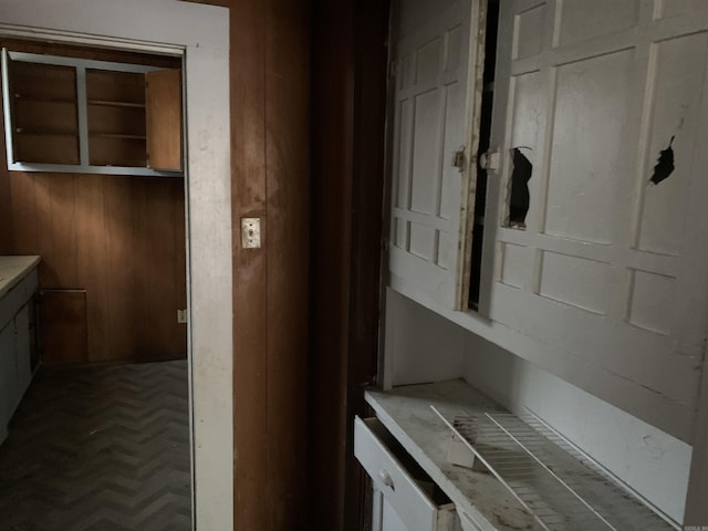 interior space with parquet flooring and wood walls