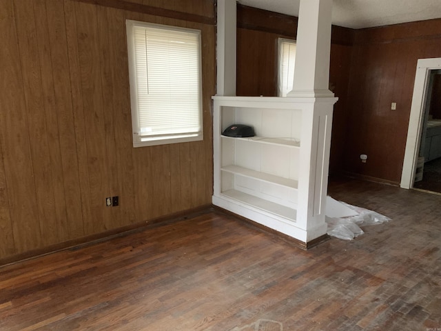 interior details featuring wood-type flooring and wood walls