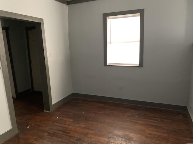 unfurnished room featuring dark hardwood / wood-style flooring