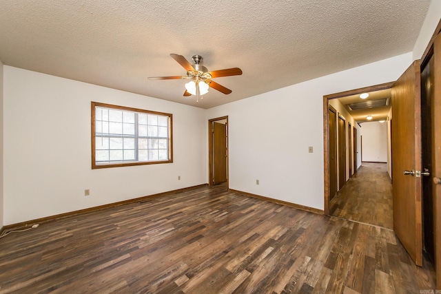 spare room featuring a textured ceiling, ceiling fan, and dark wood-type flooring