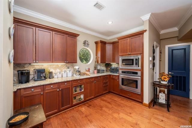 kitchen featuring light hardwood / wood-style flooring, light stone countertops, ornamental molding, tasteful backsplash, and stainless steel appliances