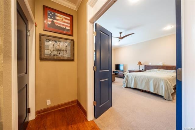 bedroom with ceiling fan, hardwood / wood-style floors, and crown molding